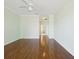 Empty bedroom boasts hardwood floors, a ceiling fan, and neutral paint at 10285 Velvetseed Cir, Spring Hill, FL 34608