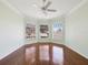 Bright bedroom features shiny wood floors, crown molding, and a bay window at 10285 Velvetseed Cir, Spring Hill, FL 34608
