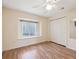 Bright bedroom featuring a ceiling fan, closet, hardwood floors and natural light at 10285 Velvetseed Cir, Spring Hill, FL 34608