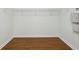 Walk-in closet with wood floor, wire shelving, and security keypad at 10285 Velvetseed Cir, Spring Hill, FL 34608