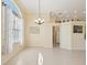 Dining room with a chandelier, large window and views of the kitchen and living spaces at 10285 Velvetseed Cir, Spring Hill, FL 34608