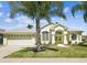 Charming one story home with a three car garage and manicured front lawn at 10285 Velvetseed Cir, Spring Hill, FL 34608