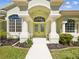Inviting front entrance with double doors, decorative columns and elegant archway at 10285 Velvetseed Cir, Spring Hill, FL 34608
