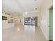 Open-concept living area with tiled floors, large windows, and access to the kitchen at 10285 Velvetseed Cir, Spring Hill, FL 34608