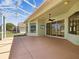 Covered patio with fan overlooking the landscaped yard, perfect for relaxing at 10285 Velvetseed Cir, Spring Hill, FL 34608