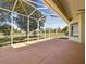 Covered patio providing a serene outdoor space with scenic backyard views at 10285 Velvetseed Cir, Spring Hill, FL 34608