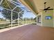 Covered patio provides ample space for outdoor entertaining with scenic backyard views at 10285 Velvetseed Cir, Spring Hill, FL 34608