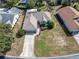 An aerial view of the house and its landscaping, showing a long driveway at 10308 Pineneedles Dr, New Port Richey, FL 34654