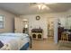 Main bedroom features a ceiling fan, a bed, and a doorway to the main bath at 11739 Bayonet Ln # B, New Port Richey, FL 34654
