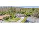 Sprawling single-Gathering home with a large yard, mature trees, and a long driveway leading to an attached garage at 12215 Snead Pl, Tampa, FL 33624