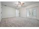 Bright, carpeted bedroom with French doors and a ceiling fan at 12215 Snead Pl, Tampa, FL 33624