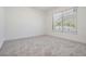 Bright bedroom with carpet flooring and a view of the pool through the window at 12215 Snead Pl, Tampa, FL 33624