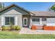Charming front entrance with brick pathway, wooden planter boxes, and a white-framed glass door at 12215 Snead Pl, Tampa, FL 33624