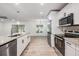 Modern kitchen with stainless appliances, granite counters and an open concept into the living space at 12215 Snead Pl, Tampa, FL 33624