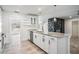 Modern kitchen with stainless steel appliances, granite countertops, and a view of the living area with fireplace at 12215 Snead Pl, Tampa, FL 33624