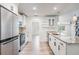 Modern kitchen with a granite island, stainless steel appliances, and new cabinets, open to the living area at 12215 Snead Pl, Tampa, FL 33624
