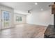 Bright living room with light wood-look floors, a front door, and large window at 12215 Snead Pl, Tampa, FL 33624