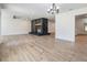 Spacious living room with a rock fireplace and wood-look flooring at 12215 Snead Pl, Tampa, FL 33624