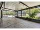 Covered patio with concrete flooring, ceiling lights and access to the backyard at 12215 Snead Pl, Tampa, FL 33624