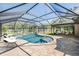Backyard pool and spa with large screened enclosure plus seating area, ideal for entertaining at 12215 Snead Pl, Tampa, FL 33624
