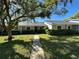 Charming single-story home with lush landscaping, mature trees and inviting walkway at 12421 Dearborn Dr # D, Hudson, FL 34667