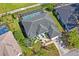 Aerial view of single-Gathering home featuring screened-in pool and mature landscaping at 12446 Quail Ridge Dr, Spring Hill, FL 34610