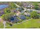 Scenic aerial view of a residential neighborhood with well-manicured lawns, pools, and mature trees at 12446 Quail Ridge Dr, Spring Hill, FL 34610