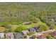 An aerial view shows the house adjacent to a beautiful common green space at 12446 Quail Ridge Dr, Spring Hill, FL 34610