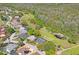 An aerial view showing the house adjacent to a common green space in the community at 12446 Quail Ridge Dr, Spring Hill, FL 34610