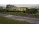 Evening shot of screened-in porch overlooking the well-manicured backyard at 12446 Quail Ridge Dr, Spring Hill, FL 34610