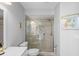 Bright bathroom with a glass-enclosed shower, modern toilet, and a vanity with neutral countertops at 12446 Quail Ridge Dr, Spring Hill, FL 34610