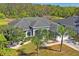 Exterior view of the house with manicured landscaping and mature palm trees at 12446 Quail Ridge Dr, Spring Hill, FL 34610