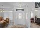Bright foyer with decorative glass door, transom window, and tile flooring leading to dining area at 12446 Quail Ridge Dr, Spring Hill, FL 34610