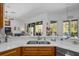 Kitchen with breakfast bar opens up to a view of the living room and screened lanai for seamless entertaining at 12446 Quail Ridge Dr, Spring Hill, FL 34610