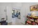 Inviting view from hallway into a bright living room with a blue sofa and comfortable furnishings at 12446 Quail Ridge Dr, Spring Hill, FL 34610