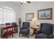 Bright living room featuring comfortable seating and a functional desk area at 12446 Quail Ridge Dr, Spring Hill, FL 34610