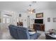 Bright living room features tile floors, ceiling fan, and comfortable seating for relaxing and entertaining at 12446 Quail Ridge Dr, Spring Hill, FL 34610
