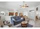 Bright living area with tile flooring, ceiling fan, and open layout connecting to kitchen and foyer at 12446 Quail Ridge Dr, Spring Hill, FL 34610