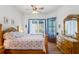 Relaxing main bedroom with a ceiling fan, wood floors, and natural light at 12446 Quail Ridge Dr, Spring Hill, FL 34610