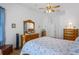 Comfortable main bedroom features wood floors, ceiling fan and ample closet space at 12446 Quail Ridge Dr, Spring Hill, FL 34610