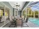 Covered patio area with outdoor dining set and view of the pool at 12446 Quail Ridge Dr, Spring Hill, FL 34610