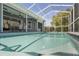 Inviting pool area with covered patio and outdoor dining space, perfect for entertaining at 12446 Quail Ridge Dr, Spring Hill, FL 34610