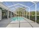 Full pool area with a screened enclosure and outdoor dining at 12446 Quail Ridge Dr, Spring Hill, FL 34610