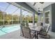 Outdoor patio with a built in grill and dining set overlooking a screened pool at 12446 Quail Ridge Dr, Spring Hill, FL 34610