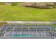 Aerial view shows a pool with a screened enclosure with a water view at 12446 Quail Ridge Dr, Spring Hill, FL 34610
