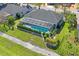 Aerial view of the pool and lanai enclosed with screen, and landscaped grounds at 12446 Quail Ridge Dr, Spring Hill, FL 34610