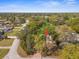 Aerial view of home surrounded by mature trees in a quiet, residential neighborhood at 1267 Meredith Dr, Spring Hill, FL 34608