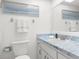 Bathroom featuring marbled countertops, a mirror, and a toilet at 1267 Meredith Dr, Spring Hill, FL 34608
