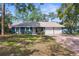 Charming single-story home with a well-maintained lawn, brick driveway, and a two-car garage at 1267 Meredith Dr, Spring Hill, FL 34608