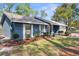 Charming one-story home boasts a well-manicured front yard with lush landscaping and cozy curb appeal at 1267 Meredith Dr, Spring Hill, FL 34608